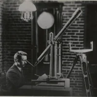 Man using telescope at UO Observatory. Circa 1900. Image owned by Lane County History Museum.