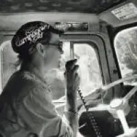 Woman driving truck for Starflower Natural Foods. Circa 1970. Photo owned by Outliers and Outlaws, The Eugene Lesbian Oral History Project - Digital Exhibit.